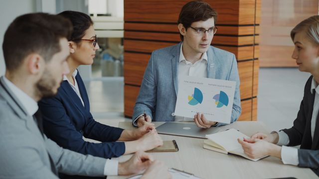 Sales team reviewing business information